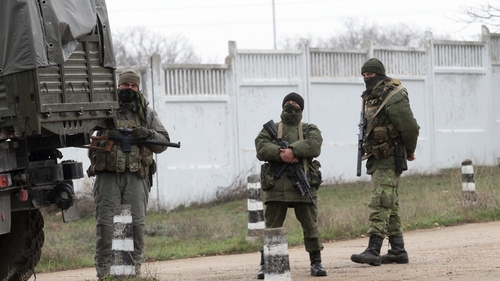Armed men in military uniform stand guard in the territory of a Ukrainian military unit in Sevastopol (Pic: EPA)