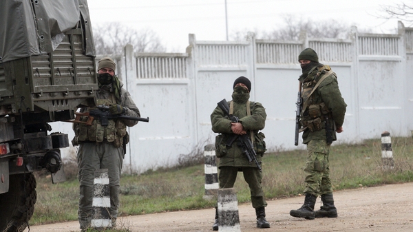 Armed men in military uniform stand guard in the territory of a Ukrainian military unit in Sevastopol (Pic: EPA)
