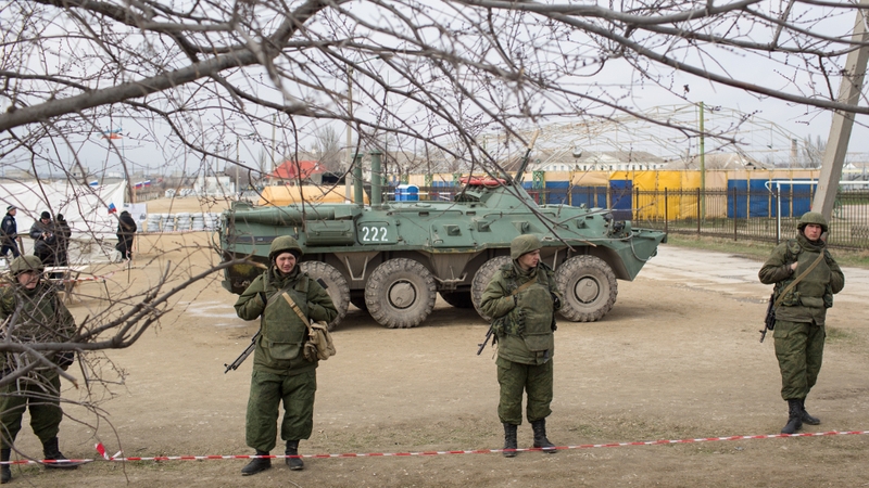 Armed soldiers stand guard outside blocked Ukraine's base of marines in Feodosia, Crimea (Pic: EPA)