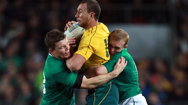 Brian O'Driscoll and Keith Earls tackle Quade Cooper of Australia during the 2011 RWC win