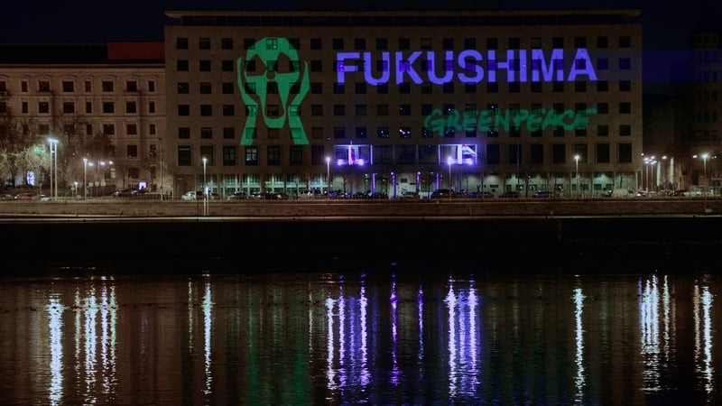 Greenpeace supporters project a message protest onto the office building of the Hungarian Parliaments' Representatives at the bank of Danube River in Budapest, during the 3rd anniversary of the Fukusima nuclear power plant disaster