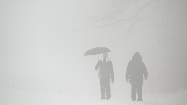People walk in thick fog on the track at Rosa Khutor Alpine Center as the Giant Slalom race of the Super Combined event was canceled due to bad weather and thick fog at the Sochi 2014 Paralympic Games (Pic: EPA)