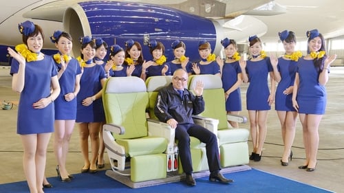 Skymark president Shinichi Nishikubo poses with cabin crew