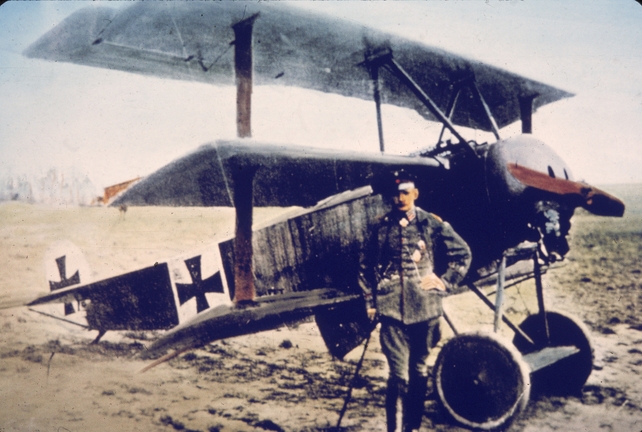 German flying ace Heinrich Gontermann (1896 - 1917) stands near his Fokker DR-1 tri-plane on an airfield in Germany in the 1910s. Gontermann, who had 39 victories as a fighter pilot, was killed in this aircraft when it broke up in the air