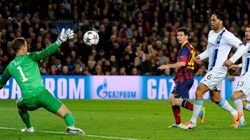 Lionel Messi dinks the ball past Joe Hart in the Man City goal to give Barca the lead