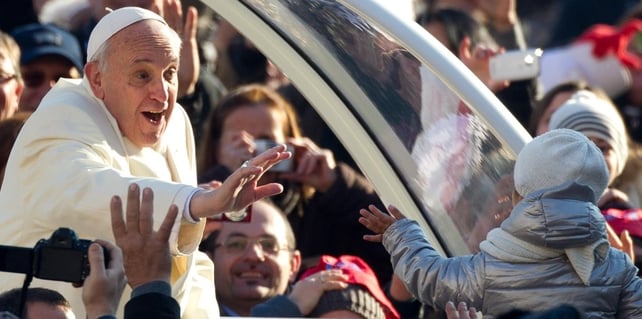 Pope Francis waves to a child as he moves around St Peter's Square (Pic: EPA)