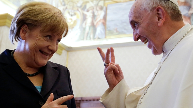 Pope Francis jokes with German Chancellor during a meeting in May last year
