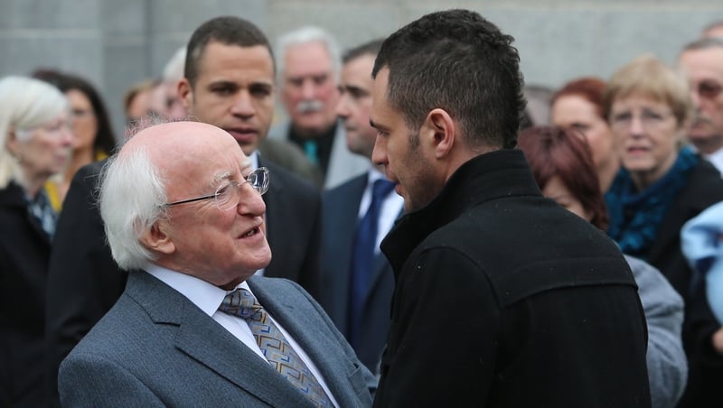 President Michael D Higgins consoles Christine Buckley's son Darragh at today's funeral mass