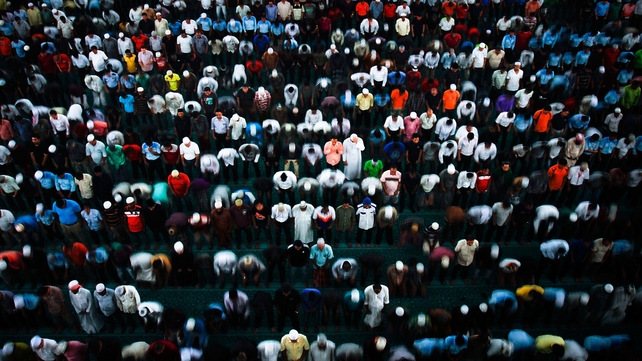 Members of the public, MAS staff, and politicians pray during a special prayer as the search for missing Malaysian airline MH370 expands to the Indian Ocean