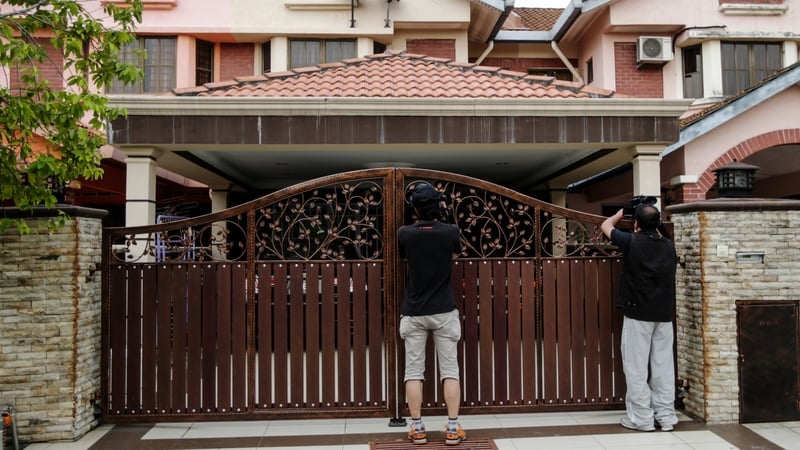 Photographers gather outside the home of co-pilot Fariq Abdul Hamid (Pic: EPA)