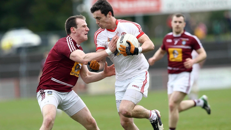 Tyrone's Shay McGuigan with Westmeath's John Gilligan