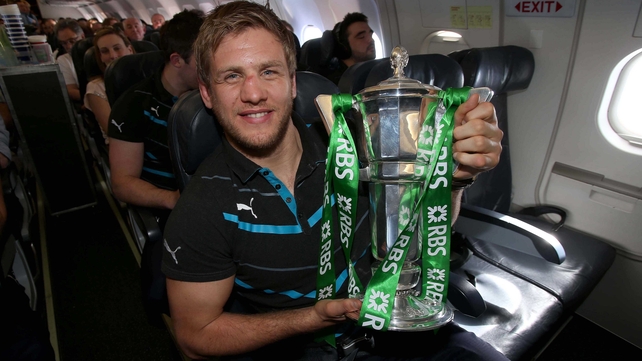 Chris Henry with the trophy aboard the team's flight home