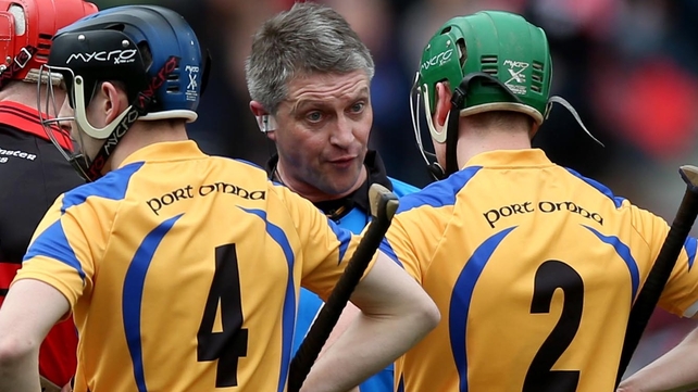 Referee Barry Kelly speaks to Conor O'Hare and Gareth Heagney
