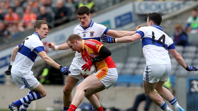 'Surrounded': Tom Cuniffe protects the ball under huge pressure from St Vincent's players