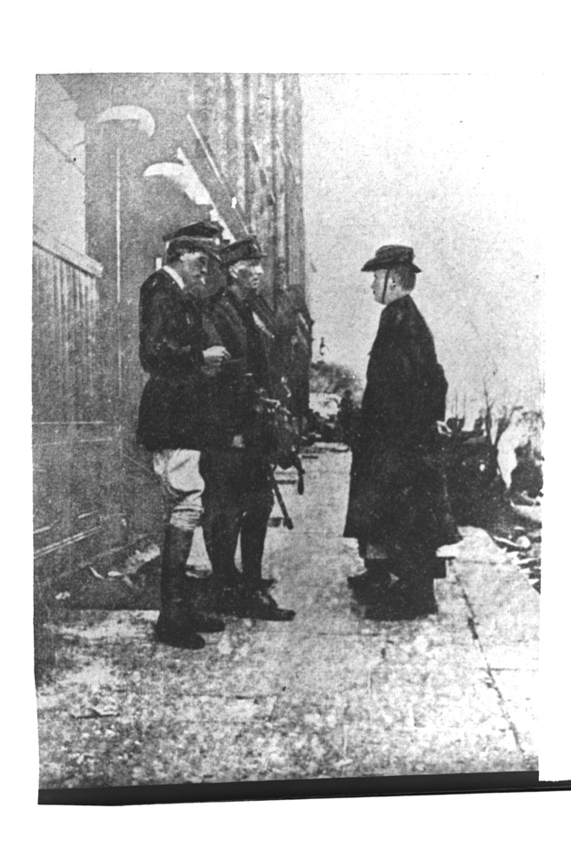 Cumann na mBan member Elizabeth O'Farrell stood beside Padraig Pearse as he surrendered to John Lowe and Brigadier-General William Lowe. Only her feet are visible (Pic: RTÉ Stills Library)