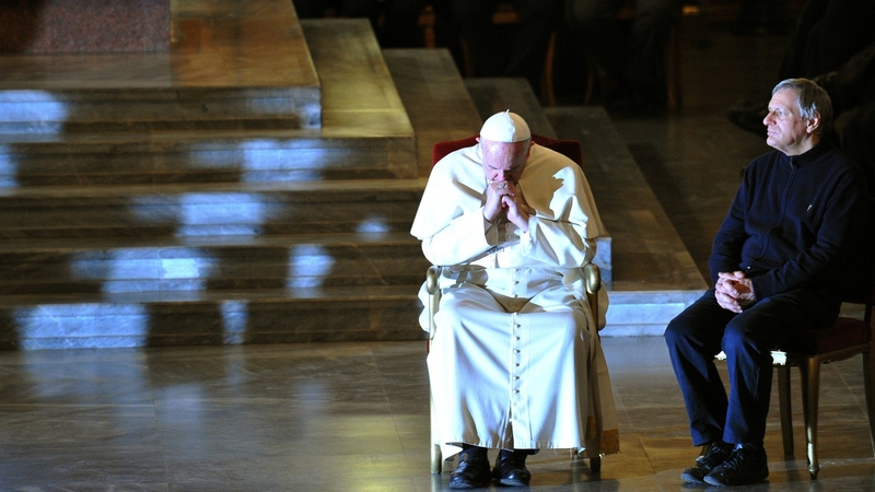 Pope Francis sits next to Father Luigi Ciotti of the Catholic Libera association in San Gregorio church