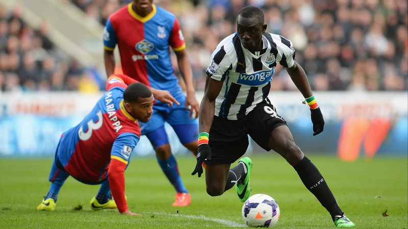 Papiss Demba Cisse goes past Adrian Mariappa of Crystal Palace