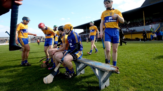 Someone's hurley enters frame left as Clare players prepare for their team photo