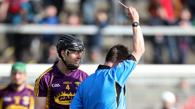 Bobby Kenny of Wexford is shown a straight red card by referee in Wexford's clash with Cork Barry Kelly