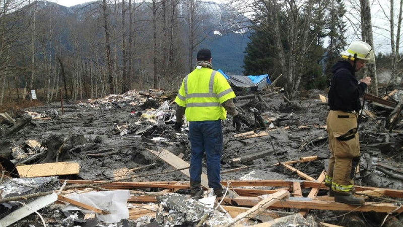 Emergency workers examine debris after a mudslide in Snohomish County, Washington
