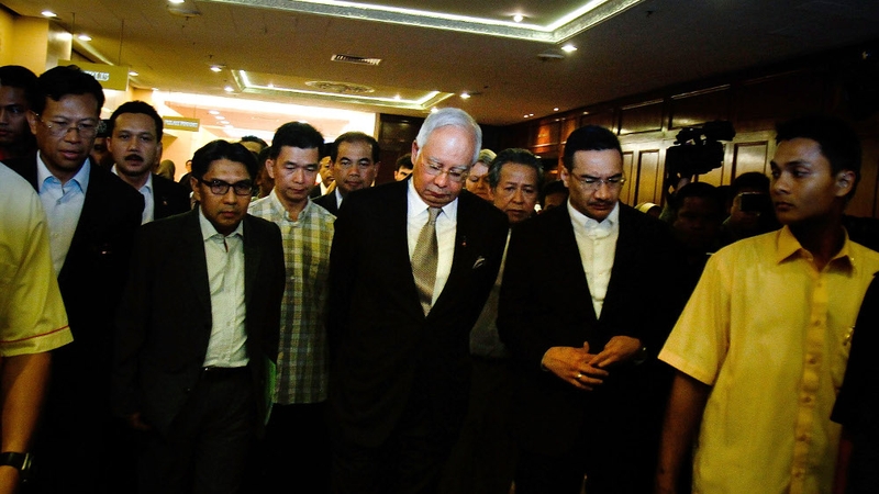 Malaysia's Prime Minister Najib Razak leaves after a news conference to announce that new data has concluded that flight MH370's final position was in the southern Indian Ocean