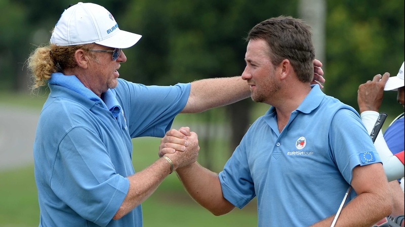 Miguel Angel Jimenez congratulates Graeme McDowell after his win