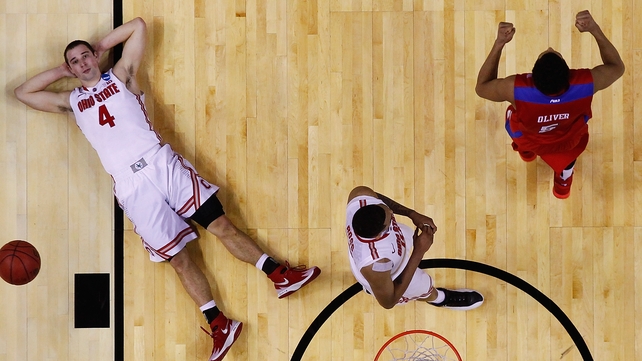 Aaron Craft (l) of the Ohio State Buckeyes reacts after losing to the Dayton Flyers in Buffalo, New York