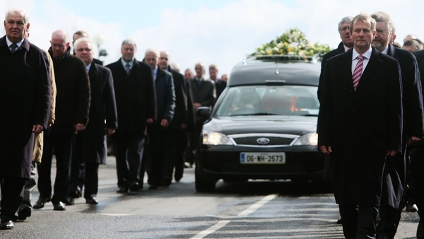 Members of the Fine Gael parliamentary party led by Taoiseach Enda Kenny form the cortege as the hearse leaves Our Lady Queen of Peace Church