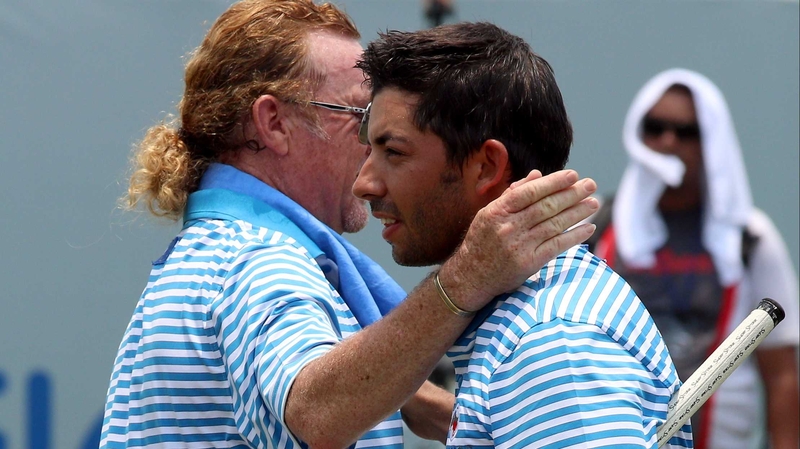 Miguel Angel Jimenez congratulates Pablo Larrazabal after he sank a putt at the 18th