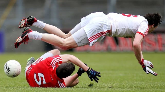 Tomas Clancy and Colm Cavanagh collide in the thrilling Cork-Tyrone encounter