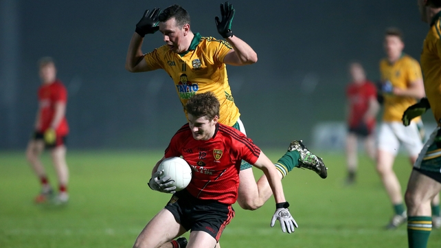 Down's Conor Maginn takes the ball and falls with Andrew Tormey nearby