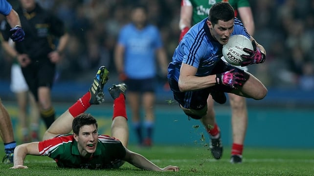 Dublin's Rory O'Carroll goes flying as Mayo's Alan Freeman watches on in Croke Park, Dublin
