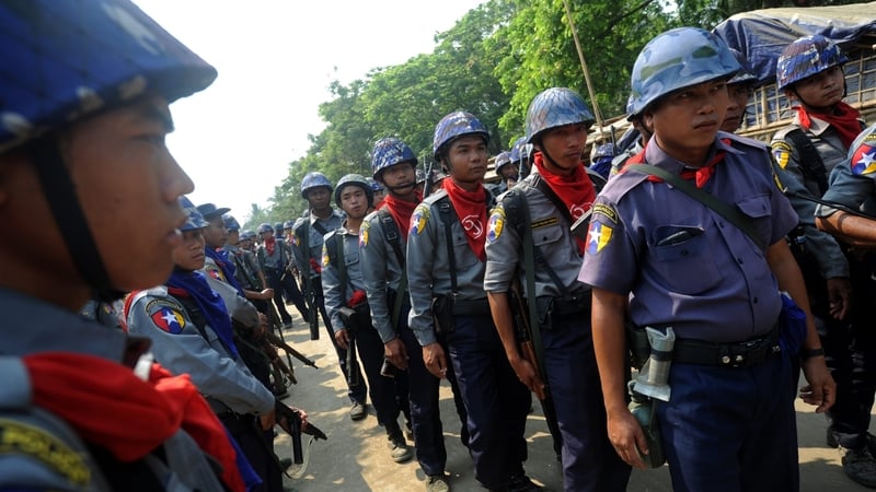 Burmese police provide security during census taking in the village of Theechaung in western Burma