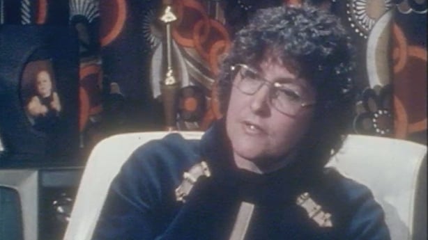 Josie Airey, a woman with dark curly hair and glasses