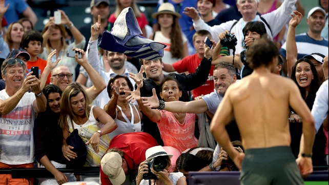 Rafael Nadal of Spain throws his towel into the crowd after his match against Denis Istomin of Uzebekistan during the Sony Open in Key Biscayne, Florida