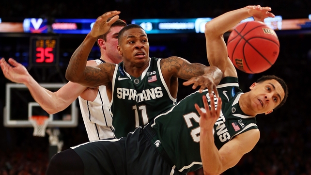 Two Michigan State Spartans fight for the loose ball during the the 2014 NCAA Men's Basketball Tournament at Madison Square Garden in New York City