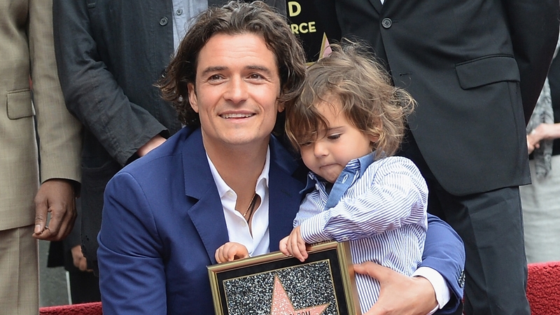 Orlando Bloom with his son Flynn as he receives a star on the Hollywood Walk of Fame