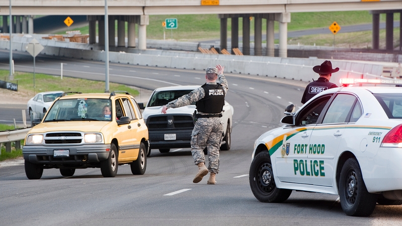 Military police direct traffic outside Fort Hood military base (Pic: EPA)