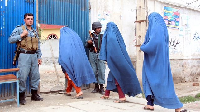 Afghan women walk past soldiers as they cast their votes in the presidential election (Pic: EPA)