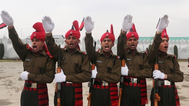 New recruits of the Jammu and Kashmir Light Infantry Regiment stand to attention during the passing out parade at an Indian Army in Srinagar