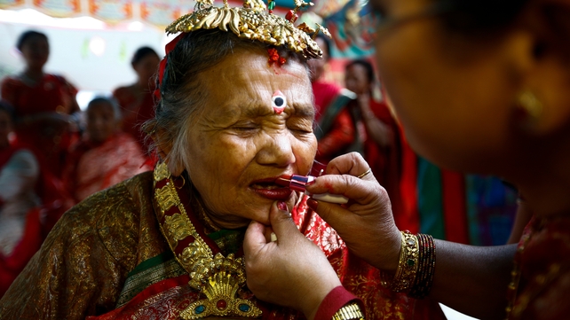 Relatives make-up elderly Nepalese woman Laxmi kumari Manandhar during preparations for 'Janku' tradition in Kathmandu (Pic: EPA)