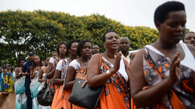People clap as they wait for the arrival of the Kwibuka Flame of Remembrance in the Kicukiru district of Kigali provice, Rwanda, as it makes its way through the country's 30 districts