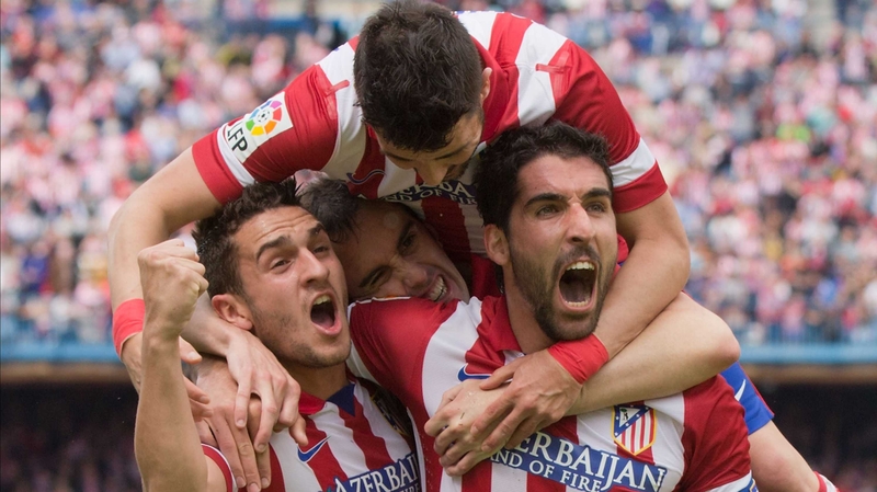 Raul Garcia (R) of Atletico de Madrid celebrates scoring with teammates Koke, Diego Godin and David Villa