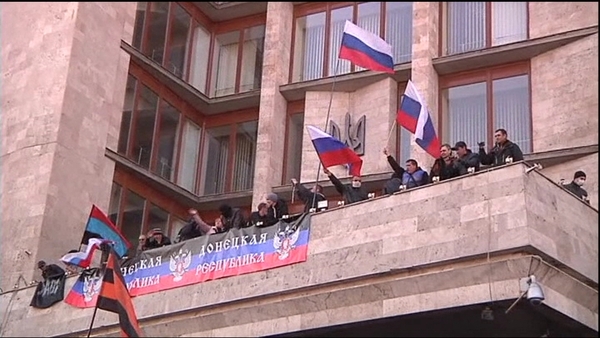 The activists raised a Russian flag over the building after similar protests in the eastern cities of Donetsk and Lugansk