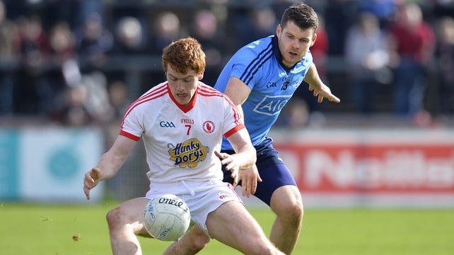 Tyrone's Peter Harte and Kevin McManamon of Dublin have eyes on the ball in Omagh