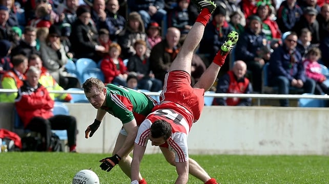 James Kearney from Derry in an acrobatic pose at McHale Park with Ger Cafferkey watching on