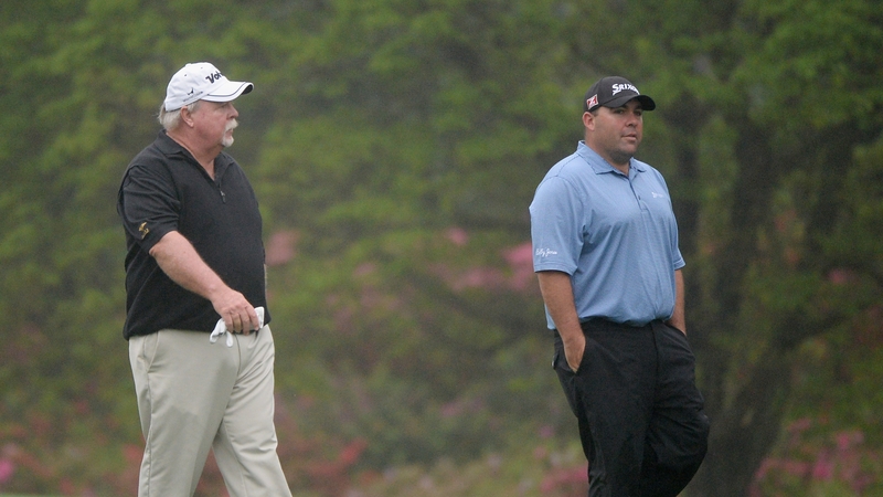 Kevin Stadler (right) walks with his father Craig during a practice round prior to the Masters