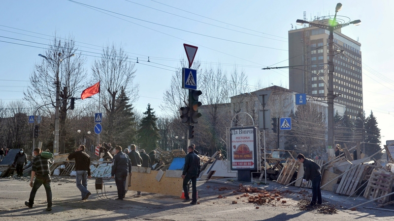 Pro-Russian activists reinforce a barricade in front of the security service headquarters in Luhansk