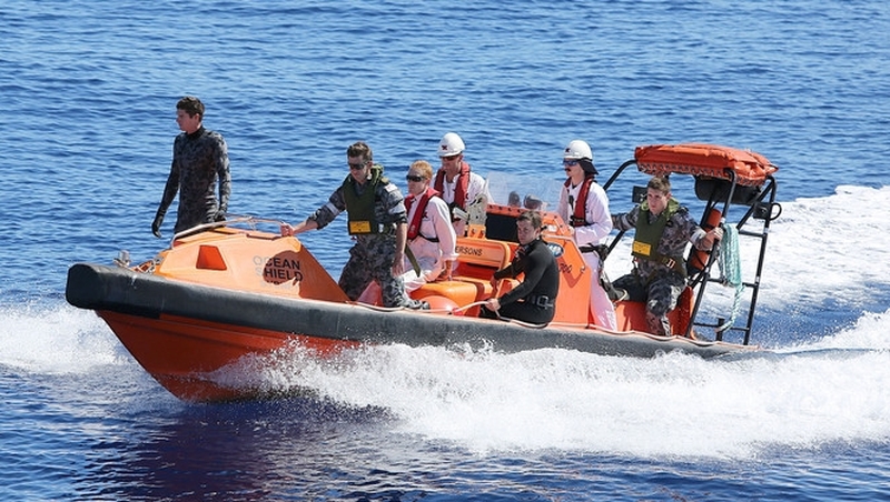 Navy personnel search the ocean for debris of the missing flight