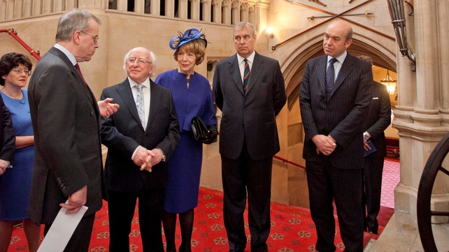 President Higgins and his wife Sabina listen to David Rankin-Hunt as the history of the regimental standards is explained